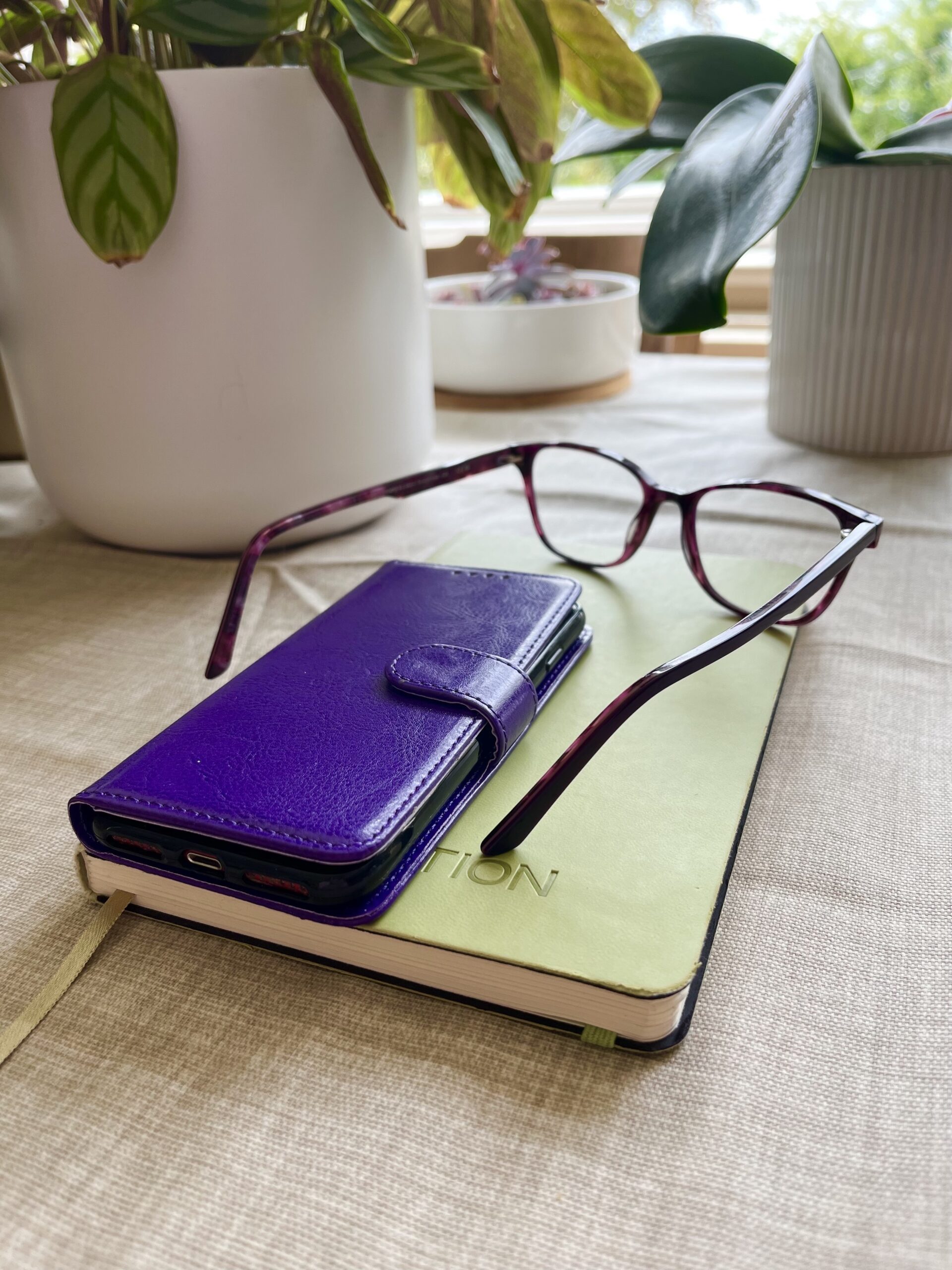 phone, notebook, glasses